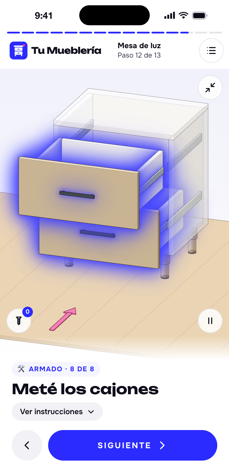 Un manual de armado en 3D abierto en el celular: el paso de meter los cajones de una mesa de luz